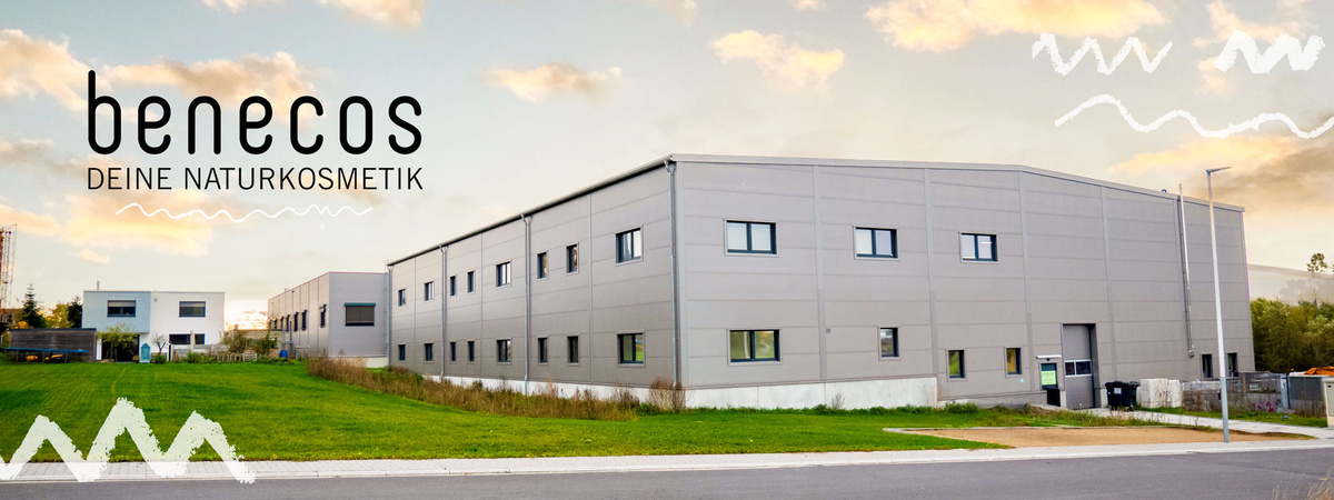 KI generiert: Industriegebäude im Grünen mit Text: "benecos DEINE NATURKOSMETIK".