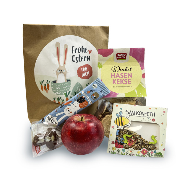KI generiert: Eine Ostertasche mit Snacks, Apfel und Saatkonfetti. Text: "Frohe Ostern", "Dinkel Hasen Kekse", "SAATKONFETTI".
